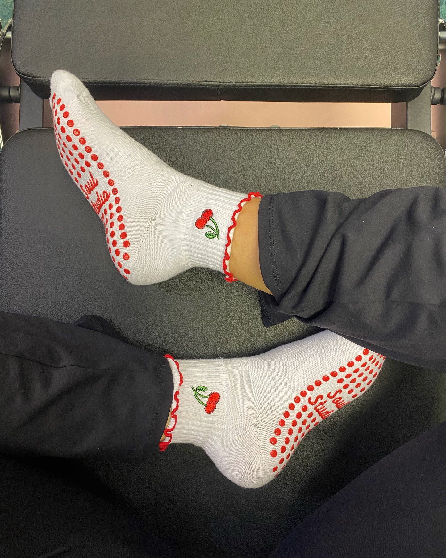 Red cherry Pilates grip socks on reformer